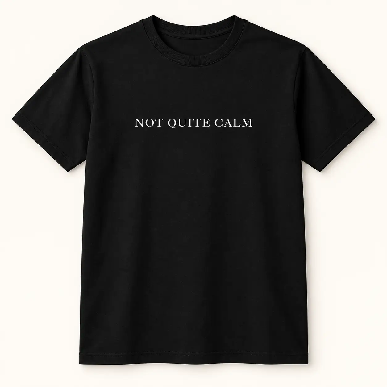 Black T-shirt with white “Not Quite Calm” text across the chest